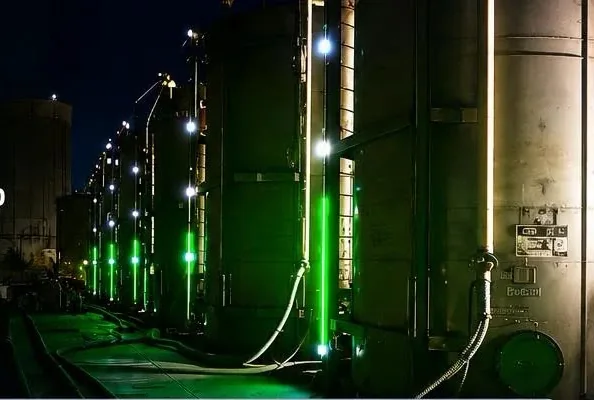 A tank battery at night with SHIELD level indicators glowing on the shells.